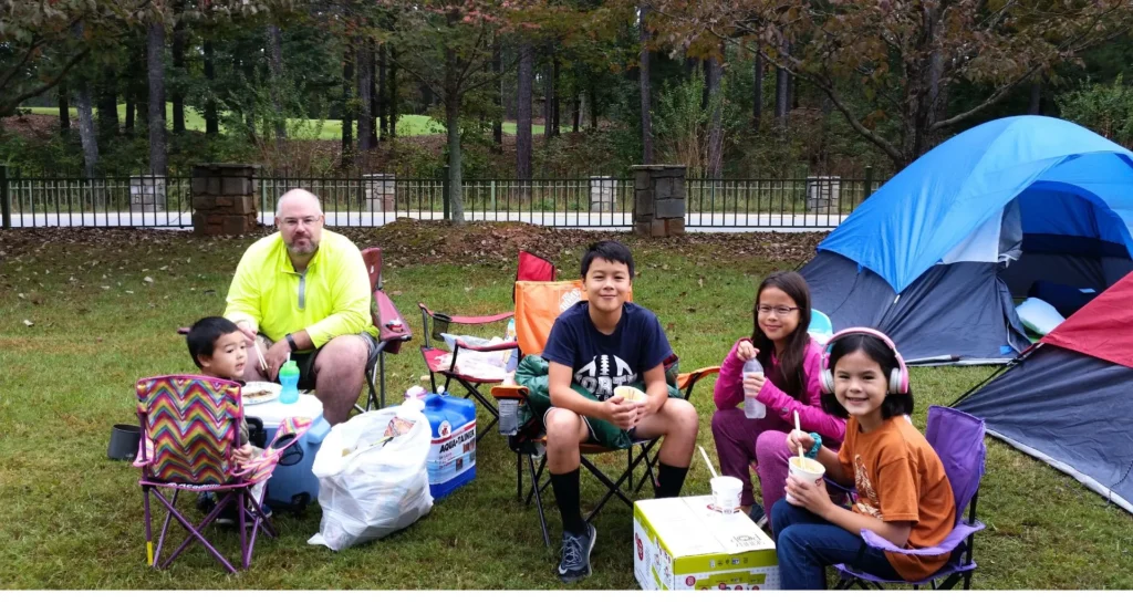 Family eating dinner at a campground overflow site with no campfire allowed