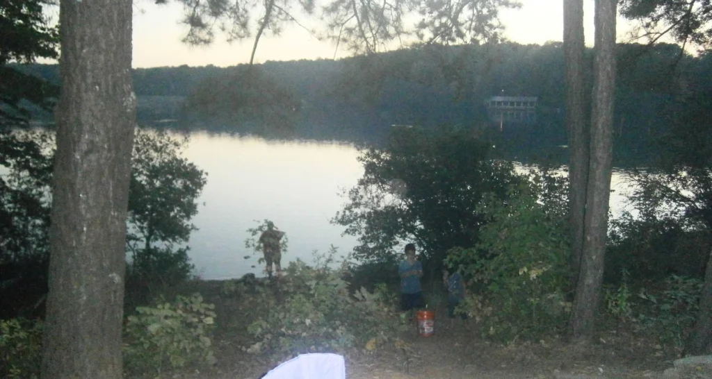 Hilly campsite on a slope overlooking a lake